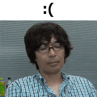 a man wearing glasses and a plaid shirt with a smiley face on his face .
