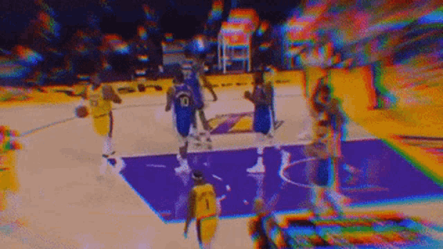 a group of basketball players are playing a game of basketball on a purple court .