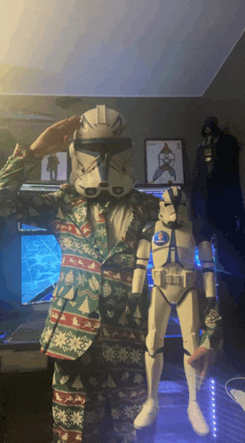 a man in a christmas suit salutes a stormtrooper
