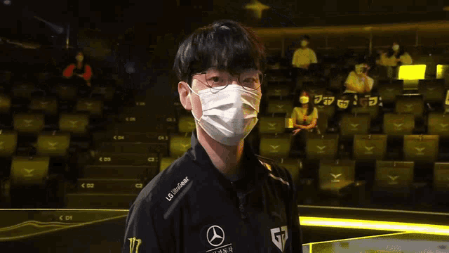 a man wearing a mask and a mercedes shirt