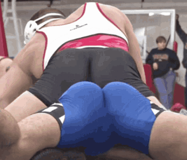 a wrestler with the word texas on his sweatshirt is wrestling another wrestler
