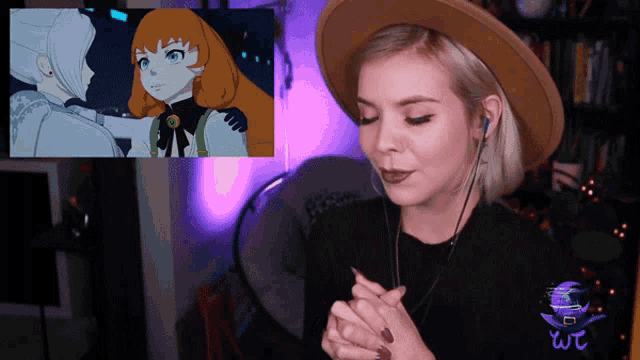 a woman wearing a hat and earbuds looks at a picture of a girl