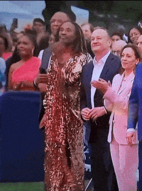 a woman in a sequined dress stands in front of a crowd