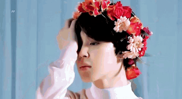 a young girl wearing a flower crown on her head .
