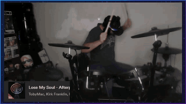 a man playing drums with the song lose my soul playing in the background