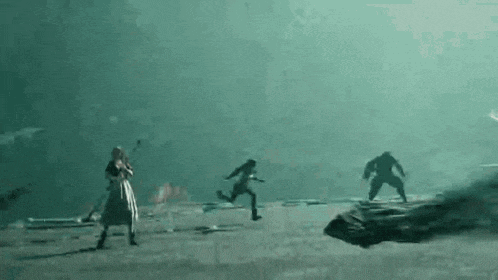 a group of people are running in a dark room .