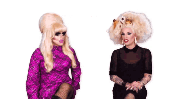 two drag queens are sitting next to each other with the words you 're just a f * cking