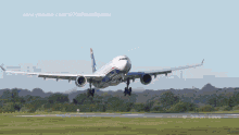 an airplane is taking off from a grassy field