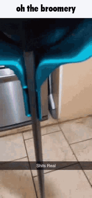 a blue high chair is sitting on a tiled floor next to a stainless steel dishwasher .