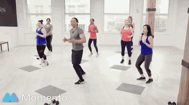 a group of women are doing exercises in a room with the word momento on the bottom
