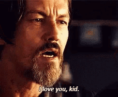 a man with a beard and mustache is saying i love you kid