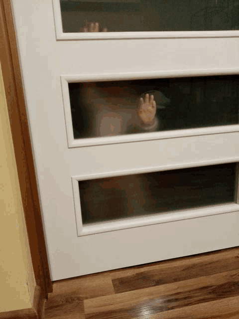 a person 's hand is sticking out of a door