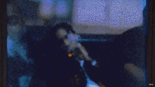 a pixelated image of a man on a television