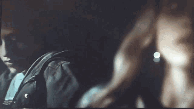 a man and a woman are sitting in a dark room