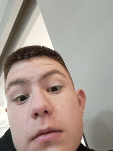 a close up of a man 's face with a serious expression