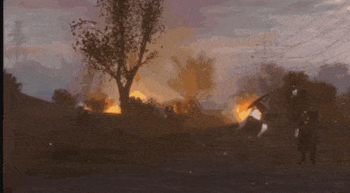 a group of people are standing in front of a burning forest