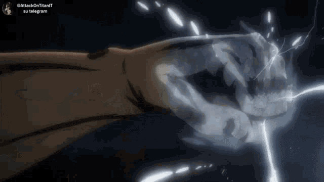 a close up of a person 's fist with a light coming out of it