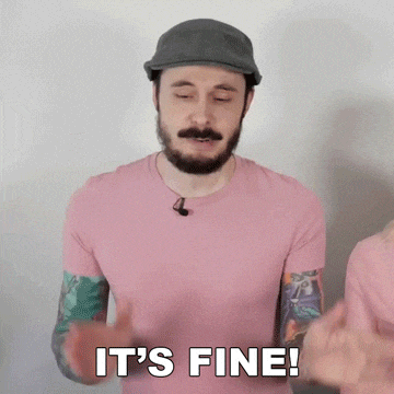 a man with a beard wearing a hat and a pink shirt says it 's fine