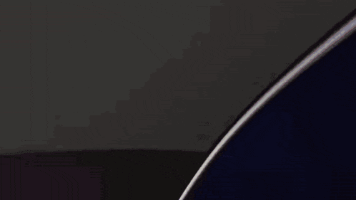 a close up of a metal object with a black background