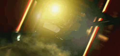a bright yellow light is shining through a smoke filled room