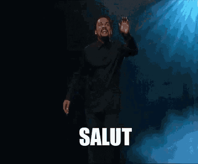 a man in a black shirt is dancing in front of a blue light and the words va te faire enculer