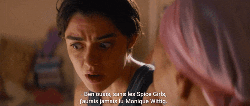 a woman with pink hair talks to another woman in a foreign language