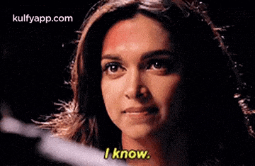 a close up of a woman 's face with the words `` i know '' written on her face .
