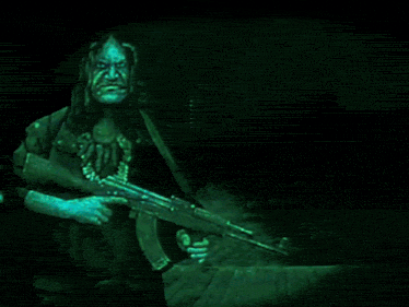 a man holding a gun in front of a picture of a woman