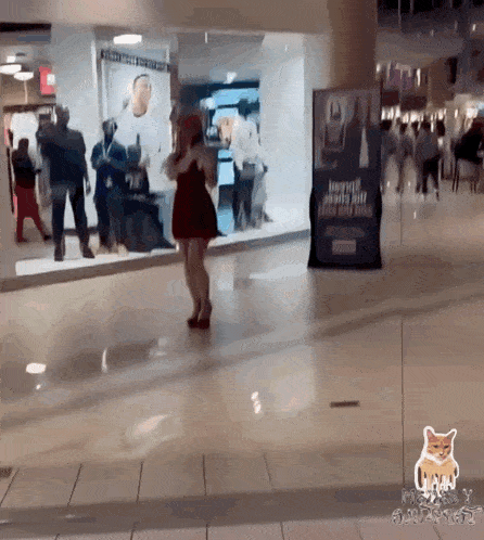 a woman in a red dress is standing in front of a store window with a sign that says ' a ' on it