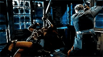 two men are fighting in a dark room with a window