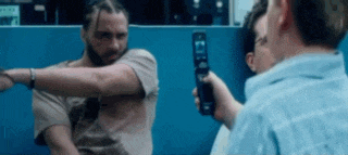 a man holding a cell phone that says ' i 'm ' on it