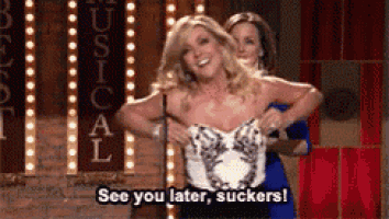 a woman in a blue dress is holding another woman 's chest and says see you later suckers
