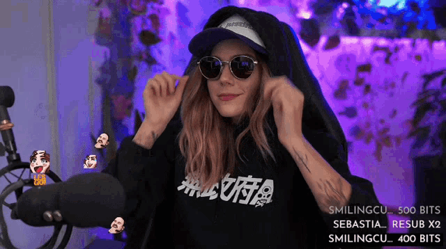 a woman wearing sunglasses and a hoodie that says " luta "
