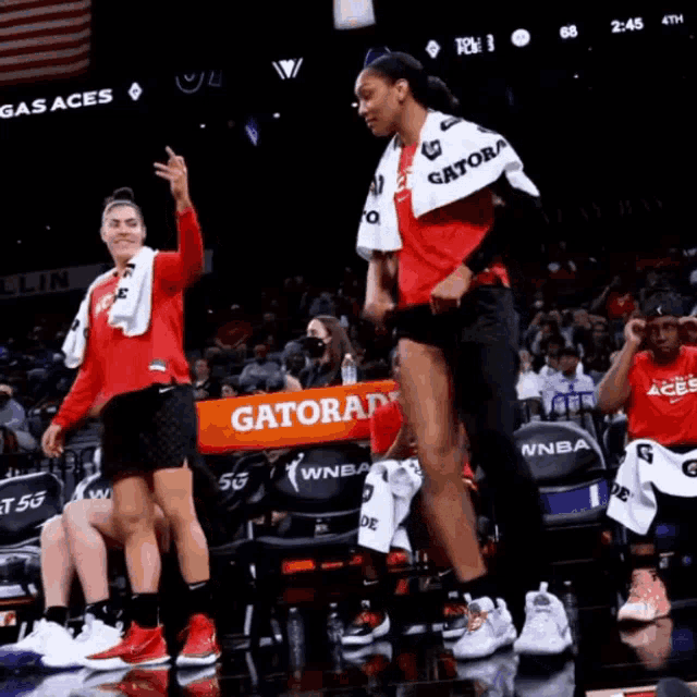 a gatorade banner is being held up by a basketball player