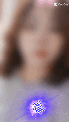 a woman 's face is blurred behind a blue and purple symbol that says ' capcut ' on the bottom