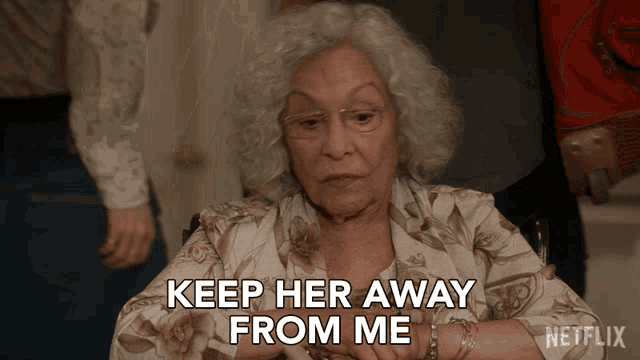 an elderly woman in a wheelchair says " keep her away from me "
