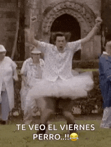 a man in a tutu is dancing in front of a group of elderly people .