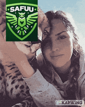 a woman is petting a cheetah with a safuu logo above her head