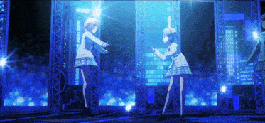 two anime girls are dancing on a stage with a blue background