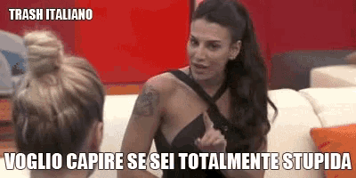 a woman in a black dress is talking to another woman on a couch with the caption trash italiano