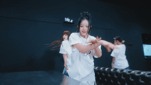 a woman wearing a white t-shirt that says n.w.i.p.s. is dancing