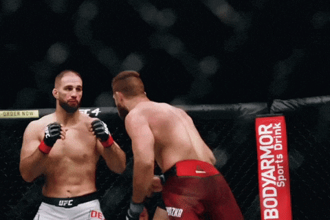 two men are fighting in a boxing ring with a bodyarmor sports drink banner in the background