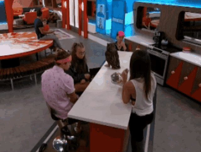 a group of people sitting at a table with a cat on it
