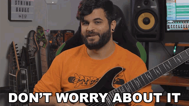 a man holding a guitar with the words " don t worry about it " below him