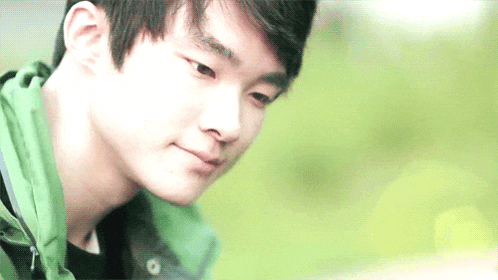 a close up of a man 's face with a green background