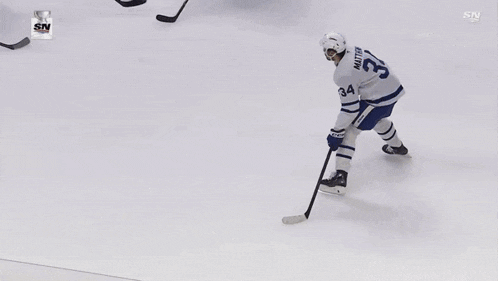 a hockey game is being played in front of a sign that says air canada