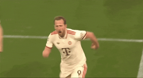 a soccer player with the number 8 on his jersey stands on the field