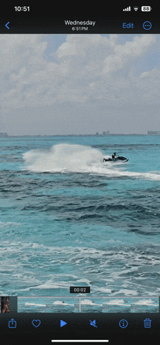 a phone screen shows a video of a jet ski in the ocean on wednesday
