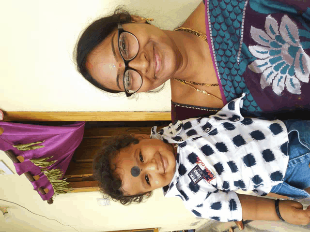 a woman and a child are posing for a picture and the child is wearing a shirt that says ' i love you '