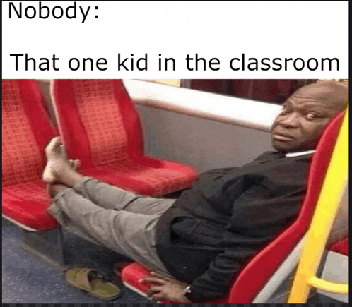 a man is sitting on a bus with his feet on the seats .